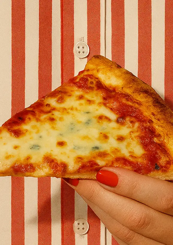 holding a slice of pizza